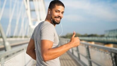 smiling athlete with earphones holding thumbs up ready training 342744 650 Proven Tips for Enhancing Men’s Health and Vitality