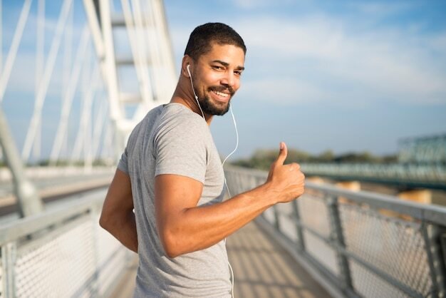 smiling athlete with earphones holding thumbs up ready training 342744 650 Proven Tips for Enhancing Men’s Health and Vitality