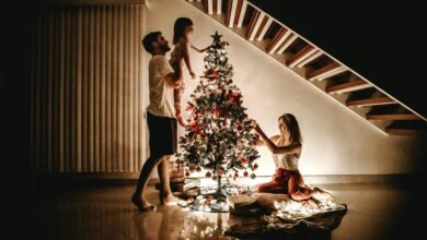 How to Celebrate a Bonded Christmas with Your Partner 5 Family decorating a Christmas tree together at home during a bonded Christmas evening