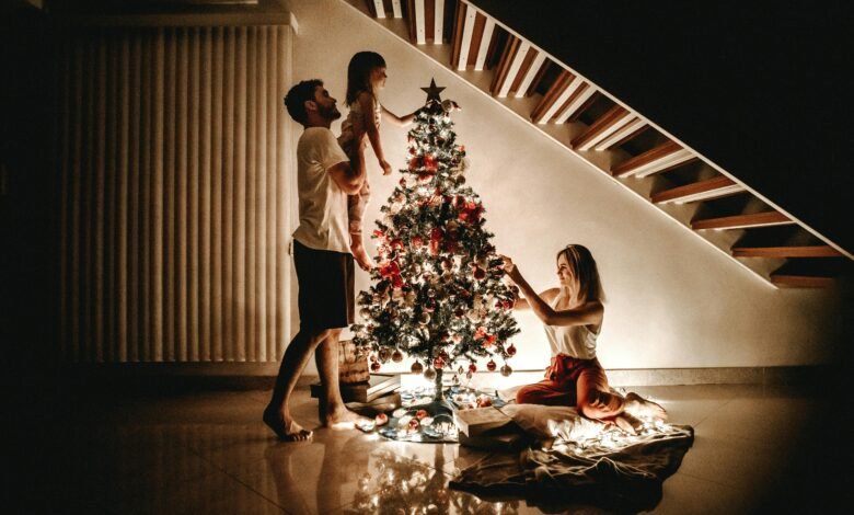 Family decorating a Christmas tree together at home during a bonded Christmas evening
